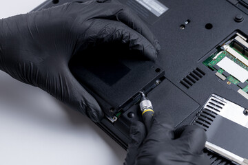 technician worker repairing laptop pc. restore hard disk data store concept. computer hardware...