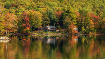 Fototapeta premium A fisherman on a lake in Massachusetts.