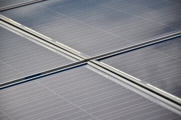 The top frames of photovoltaics on the roof.