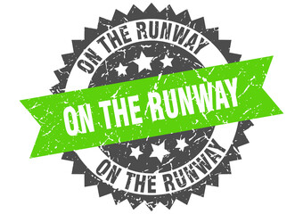 on the runway stamp. grunge round sign with ribbon