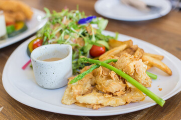 Crispy Almond Fish Steak ( Deep-fried sea fish with almond crispy) with fresh salads is a healthy delicious food.