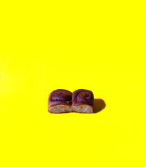 Cinnamon bread with chocolate on yellow background, pastry concept