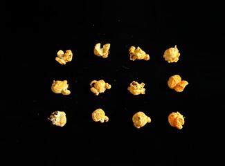Popcorn with cheese on black background, cinema concept