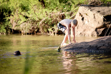 Fototapeta na wymiar Two boys swimming in the Goulburn River, New South Wales Australia. Holiday photos on Australian road trip.