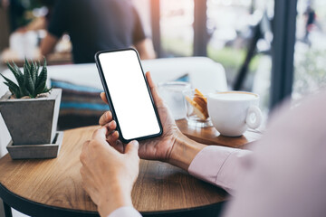 cell phone mockup blank white screen.woman hand holding texting using mobile on desk at coffee shop.background empty space for advertise.work people contact marketing business,technology