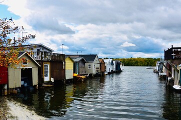 Waterfront at Canandaigua Lake, New York, with rows of rustic boathouses. 