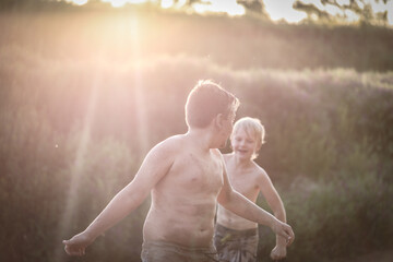 Happy brothers playing in the sand on the bank of the Goulburn River in New South Wales, Australia