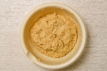 Mixed mixture of yeast dough ingredients, ready for lifting. The process of cooking in a light...