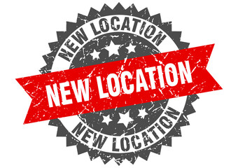 new location stamp. grunge round sign with ribbon