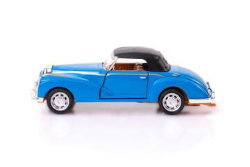 Side view of blue clasic design toy car with black roof.