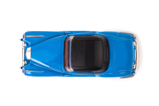 Top view of blue clasic design toy car with black roof.