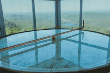 Adirondack fire tower with old compass and map with views of the mountains