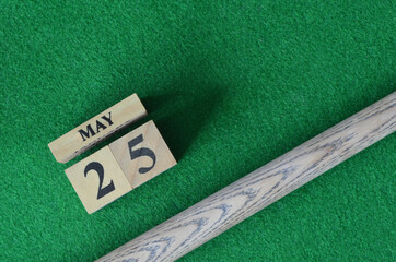 May 25, Number cube With a snooker stick on a green background, snooker table.