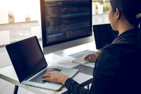 Developing programming and coding technologies working in a software engineers developing applications together in office.