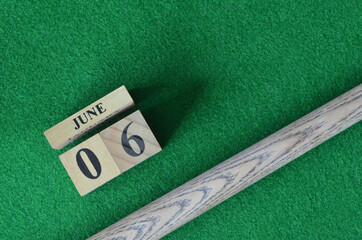 June 6, Number cube With a snooker stick on a green background, snooker table.