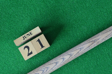 June 21, Number cube With a snooker stick on a green background, snooker table.