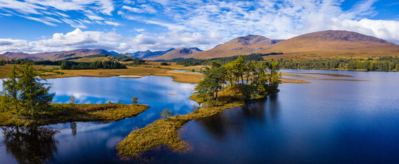 aerial drone image of loch tulla in the argyll region of the highlands of scotland during autumn on a clear bright day showing calm waters on the inland loch © Andy Morehouse