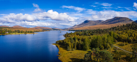 Fototapeta premium aerial drone image of loch tulla in the argyll region of the highlands of scotland during autumn on a clear bright day showing calm waters on the inland loch