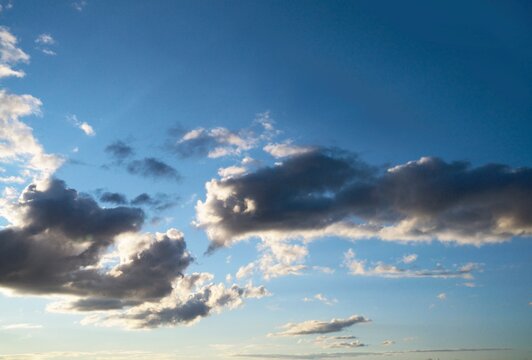 This nature image shows white clouds scattered through a blue sky.