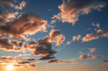 This beautiful image shows a calm blue sky filled with clouds illuminated by a glowing sun