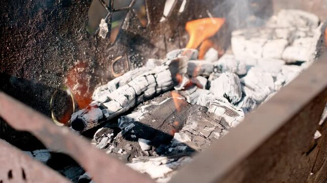 Firewood fire flames. Metal brazier grill. Close up.