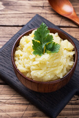 Homemade cream mashed potatoes in a dish with parsley. copy space