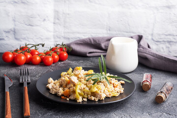 Stewed chicken minced meat with vegetables zucchini pepper spices on a black plate. copy space