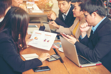 Group of business people meeting in conference room brainstorming consult business document graph chart office desk. Diversity multiethnic group of business people brainstorming and working together.