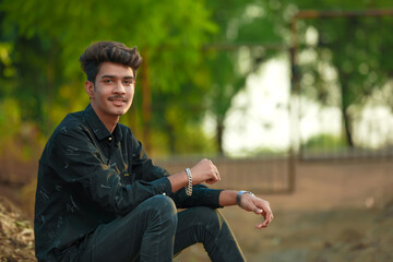 Young handsome indian man wearing black shirt