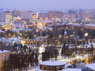 Assumption Cathedral and Dzerzhinsky Square from a height in the winter evening in Omsk.
