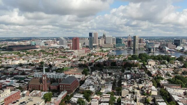 Wide aerial descending, downtown Baltimore City and Inner Harbor, homes and residential communities in foreground, Federal Hill, Riverside, Sharp Leadenhall