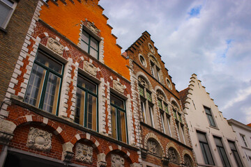Fototapeta na wymiar Roofs And Windows Of Old Authentic Brick Houses In Bruges, Belgium