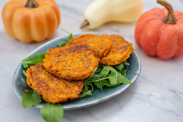 healthy home made pumkin patties with avocado and arugula salad
