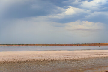 Dark storm clouds over a salt lake before a rain