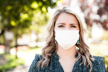 Close up Portrait of Beautiful Women in Medical Mask, 30 years Old  with blonde Hair and Big Blue Eyes, Pandemic 2020
