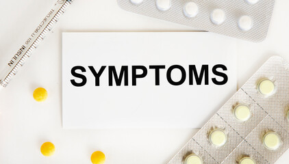 On the business card inscription SYMPTOMS, around there are table tables and blisters with pills, a syringe.