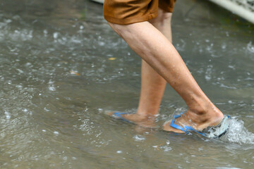 Legs walking through the flood