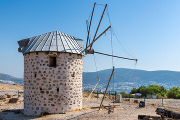 Fototapeta na wymiar Old windmill in autumn sunny day, Bodrum, Turkey. 