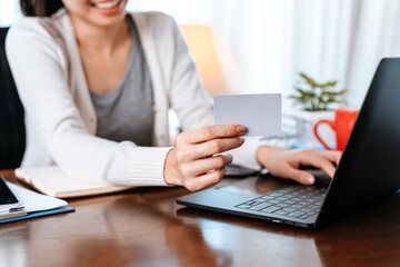 Obraz na płótnie Canvas young woman hands holding credit card and using laptop for online shopping. Credit card buy or paymaent conceptl.