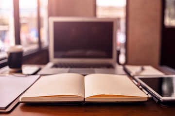 Office workplace with laptop, calculator, book and document on wood table