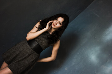 Black hair woman. Beautiful brunette hairstyle fashion portrait over dark background