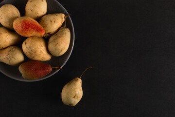 Fresh juicy appetizing pears on a gray plate, summer concept, copy space.