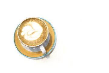 Cup and saucer with cappuccino with a pattern on the foam, close-up. On a white isolated background, top view. There is a place for an inscription.