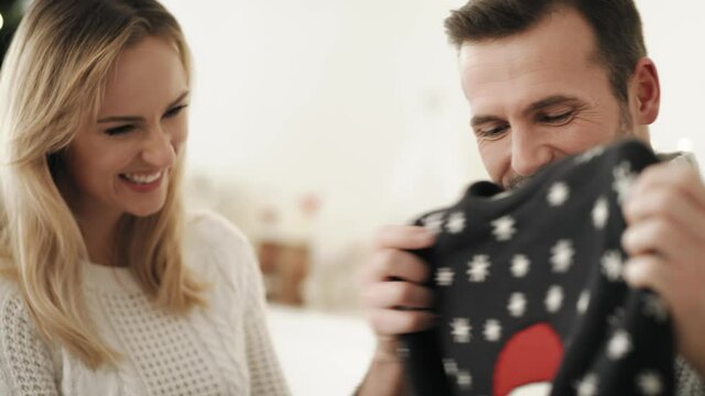 Video of men receiving ugly jumper from his wife. Shot with RED helium camera in 8K.