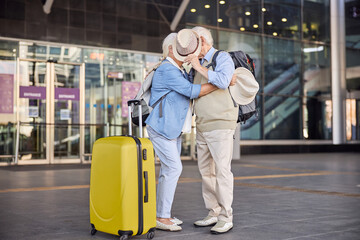 Senior couple hiding their faces behind a hat