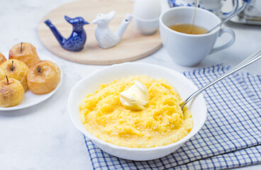 Delicious and healthy Breakfast with corn porridge and baked apples.