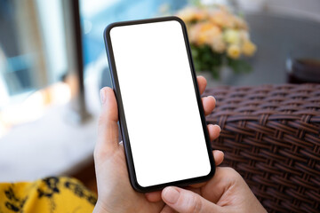 female hands in yellow dress hold phone with isolated screen
