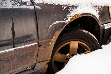 Car closeup. Fragment. Old car under the snow. Abandoned. Winter snow