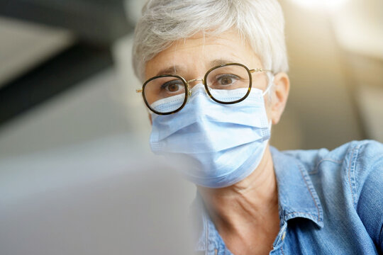 55 Year Old Senior Woman With White Hair Working Out With Mask