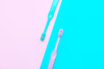 Tooth brushes on color background